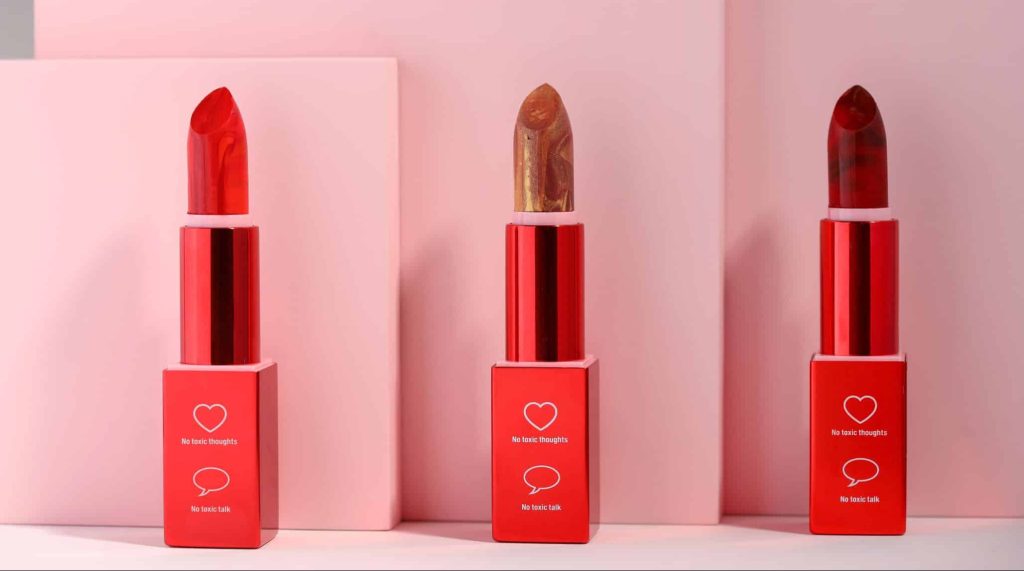 Picture of Wyrl Beauty's lipsticks in bright red, crimson, and brown.